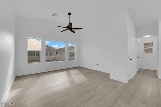 9315 Indian Corn Ct Unit 101, Las Vegas, NV 89178 - empty room featuring a ceiling fan, arched walkways, light wood finished floors, and lofted ceiling