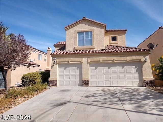256 Camino Viejo St, Henderson, NV 89012 - mediterranean / spanish-style house featuring driveway, a tiled roof, stucco siding, and stone siding