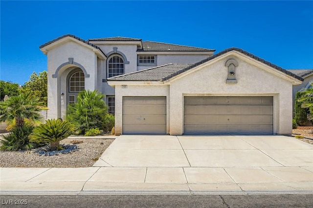5409 Flora Spray St, Las Vegas, NV 89130 - mediterranean / spanish house with a garage, a tile roof, stucco siding, and driveway