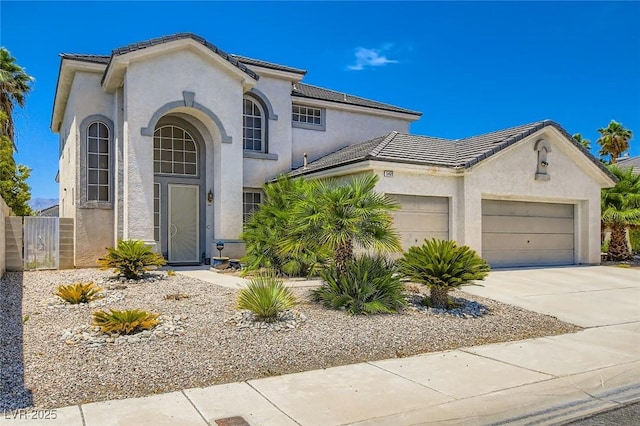 5409 Flora Spray St, Las Vegas, NV 89130 - view of front of house with an attached garage, driveway, stucco siding, and a tile roof