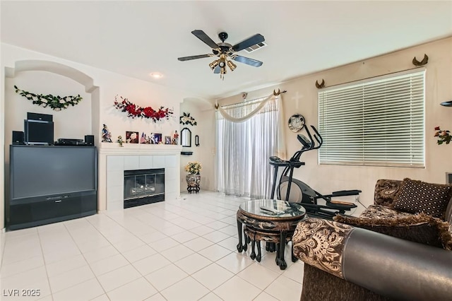 5409 Flora Spray St, Las Vegas, NV 89130 - living room featuring a ceiling fan, light tile patterned flooring, and a tile fireplace