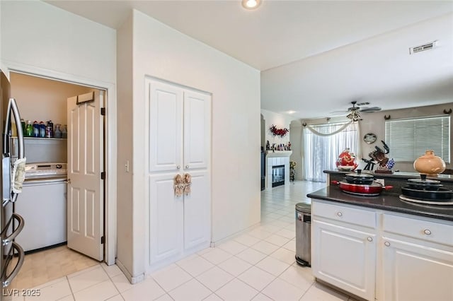 5409 Flora Spray St, Las Vegas, NV 89130 - kitchen with ceiling fan, dark countertops, white cabinetry, washer / dryer, and freestanding refrigerator