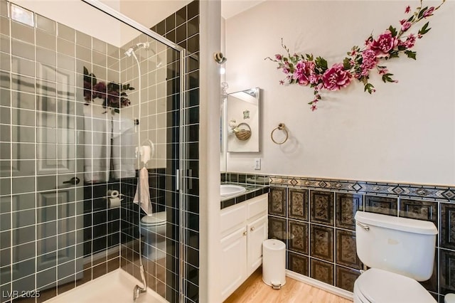 5409 Flora Spray St, Las Vegas, NV 89130 - full bath with vanity, a stall shower, wood finished floors, and wainscoting