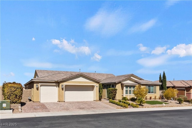 9240 Northfield Park Ct, Las Vegas, NV 89148 - ranch-style house featuring stucco siding, a garage, and decorative driveway