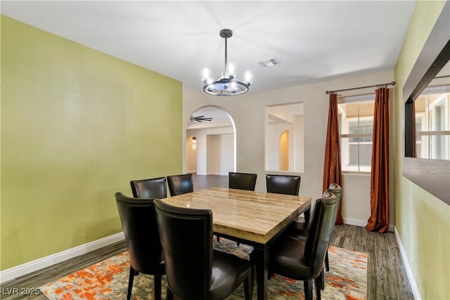 9240 Northfield Park Ct, Las Vegas, NV 89148 - dining area featuring a chandelier, wood finished floors, and arched walkways