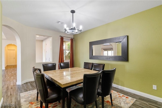 9240 Northfield Park Ct, Las Vegas, NV 89148 - dining area featuring wood finished floors, a chandelier, and arched walkways