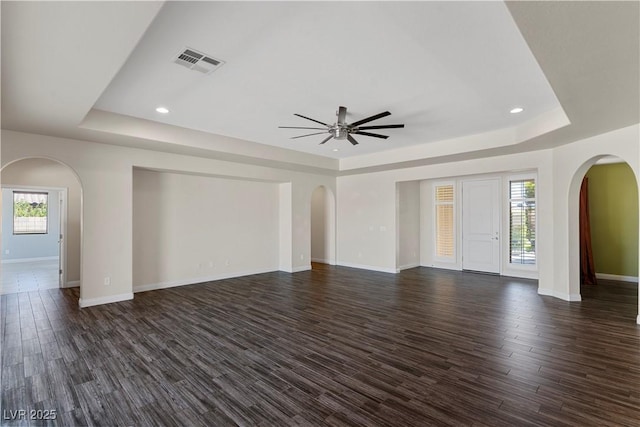 9240 Northfield Park Ct, Las Vegas, NV 89148 - unfurnished living room featuring a raised ceiling, arched walkways, a ceiling fan, and recessed lighting