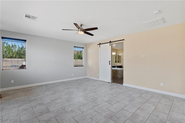 9240 Northfield Park Ct, Las Vegas, NV 89148 - unfurnished room with a barn door, healthy amount of natural light, a ceiling fan, and a smoke detector