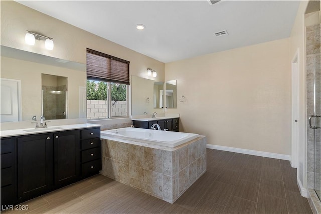 9240 Northfield Park Ct, Las Vegas, NV 89148 - full bathroom with a stall shower, two vanities, and a bath