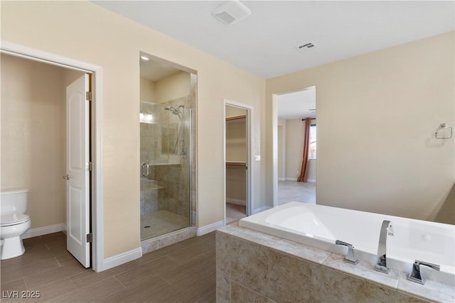9240 Northfield Park Ct, Las Vegas, NV 89148 - full bathroom featuring a stall shower, a garden tub, a walk in closet, and wood finished floors