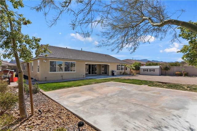 9240 Northfield Park Ct, Las Vegas, NV 89148 - rear view of property with a storage shed, stucco siding, and a patio