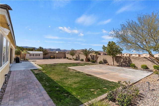 9240 Northfield Park Ct, Las Vegas, NV 89148 - fenced backyard featuring a patio, an outbuilding, and a mountain view