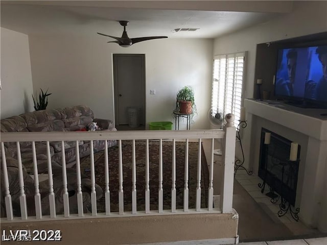 8769 Country View Ave, Las Vegas, NV 89129 - living room featuring a ceiling fan and a glass covered fireplace