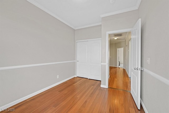 10601 Lessona St, Las Vegas, NV 89141 - unfurnished bedroom with light wood-style flooring, ornamental molding, and a closet