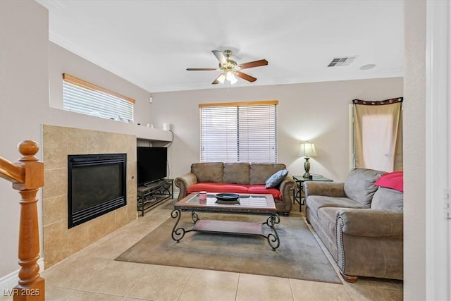 10601 Lessona St, Las Vegas, NV 89141 - living area with ceiling fan, crown molding, a tile fireplace, and tile patterned flooring