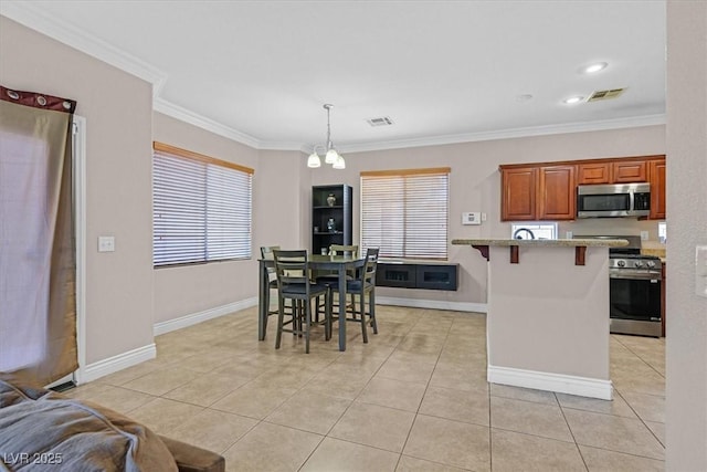 10601 Lessona St, Las Vegas, NV 89141 - kitchen featuring stainless steel appliances, a breakfast bar, light tile patterned floors, ornamental molding, and decorative light fixtures