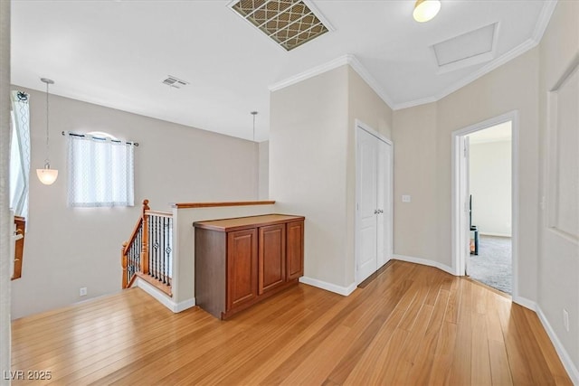 10601 Lessona St, Las Vegas, NV 89141 - hall with light wood-type flooring, crown molding, attic access, and an upstairs landing