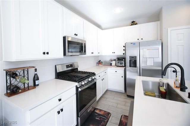 7037 Tilligerry St, North Las Vegas, NV 89084 - kitchen with appliances with stainless steel finishes, backsplash, light countertops, and white cabinets