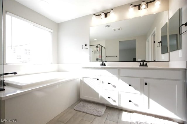 7037 Tilligerry St, North Las Vegas, NV 89084 - full bath featuring a garden tub, vanity, and a shower