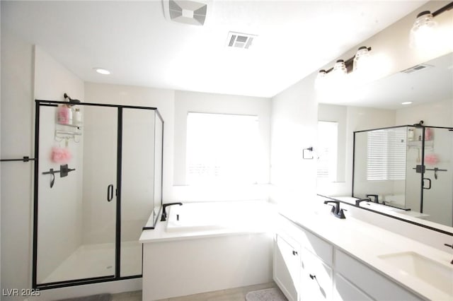 7037 Tilligerry St, North Las Vegas, NV 89084 - full bath featuring a shower stall, a garden tub, double vanity, and recessed lighting