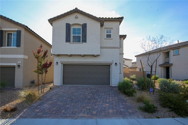 7037 Tilligerry St, North Las Vegas, NV 89084 - mediterranean / spanish home with stucco siding, an attached garage, decorative driveway, and a tile roof