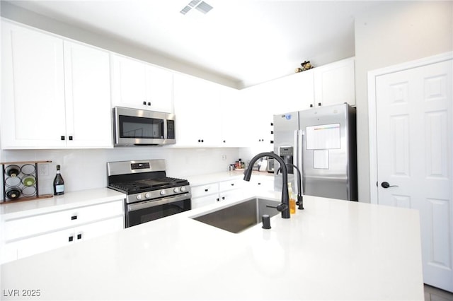 7037 Tilligerry St, North Las Vegas, NV 89084 - kitchen with stainless steel appliances, white cabinets, light countertops, and tasteful backsplash