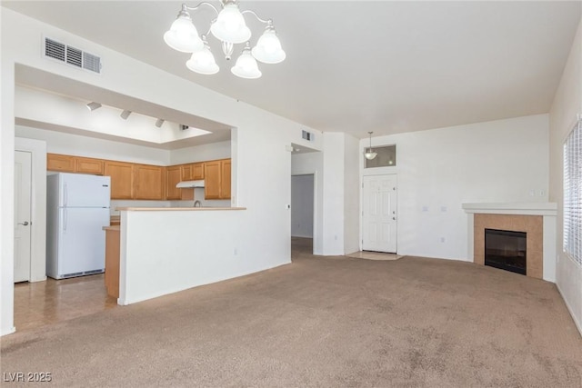 8805 Jeffreys St Unit 1003, Las Vegas, NV 89123 - unfurnished living room with a chandelier, a tile fireplace, and light carpet