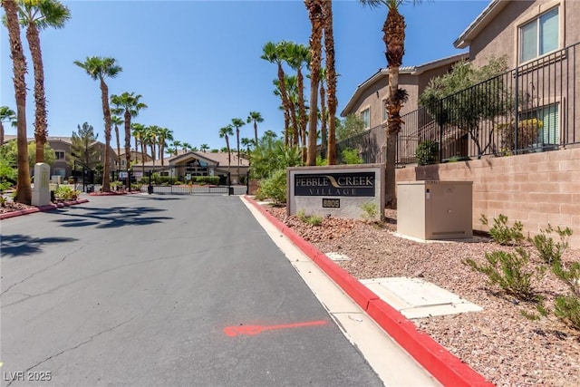 8805 Jeffreys St Unit 1003, Las Vegas, NV 89123 - view of asphalt road featuring curbs, a gated entry, and a residential view