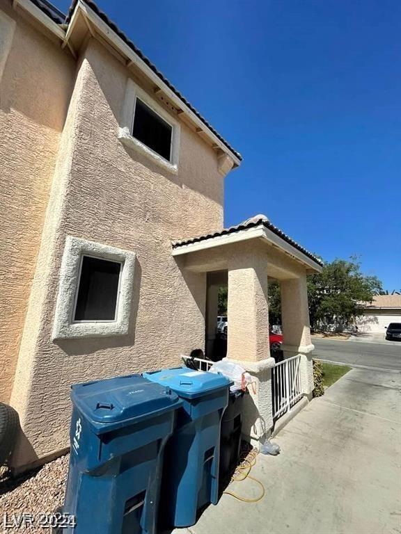 9801 Bradford Summit St, Las Vegas, NV 89183 - view of property exterior with stucco siding and a tiled roof