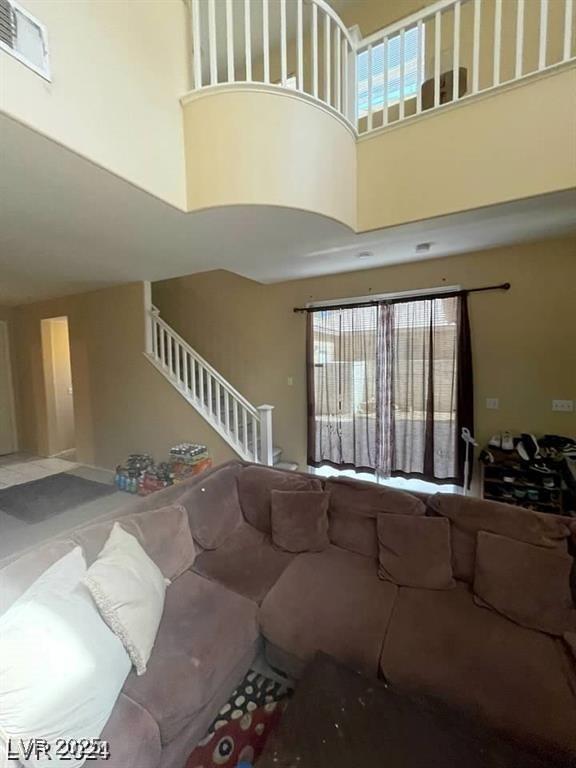 9801 Bradford Summit St, Las Vegas, NV 89183 - living area featuring a towering ceiling and stairway