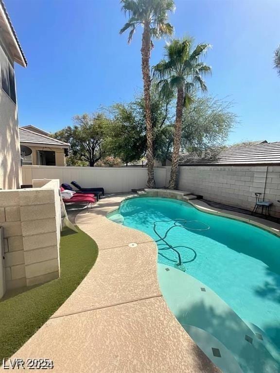 9801 Bradford Summit St, Las Vegas, NV 89183 - view of swimming pool with a fenced backyard and a patio