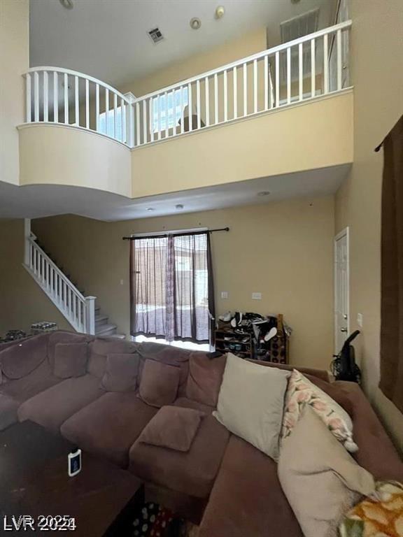 9801 Bradford Summit St, Las Vegas, NV 89183 - living room featuring a high ceiling and stairs