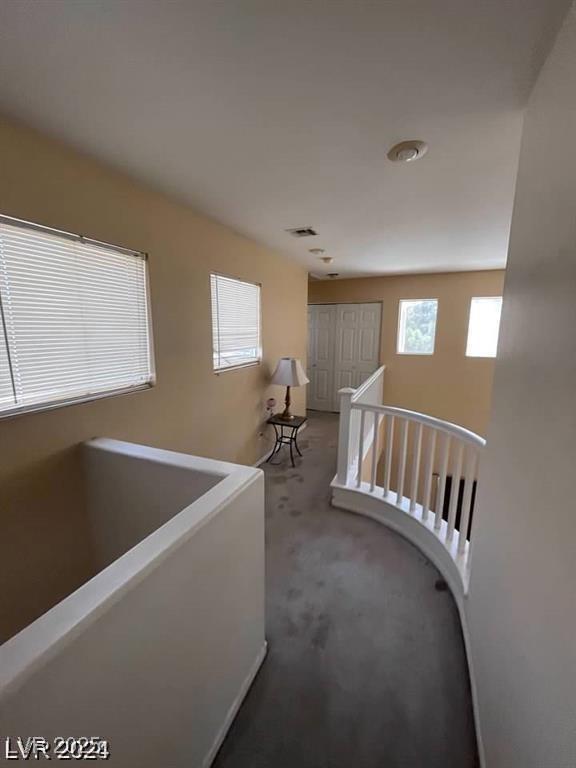 9801 Bradford Summit St, Las Vegas, NV 89183 - corridor with an upstairs landing, healthy amount of natural light, and carpet floors