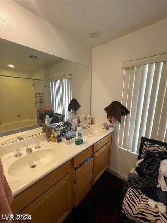 9801 Bradford Summit St, Las Vegas, NV 89183 - bathroom with double vanity and shower / bathtub combination with curtain