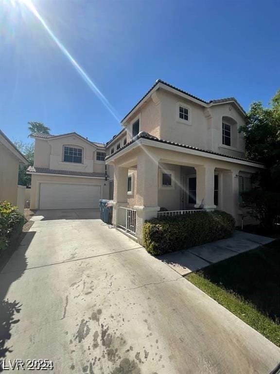 9801 Bradford Summit St, Las Vegas, NV 89183 - mediterranean / spanish house featuring stucco siding, an attached garage, and driveway