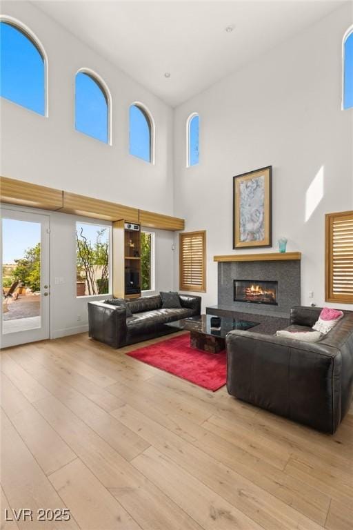 11680 Evergreen Creek Ln, Las Vegas, NV 89135 - living room with a high ceiling, a glass covered fireplace, and wood finished floors