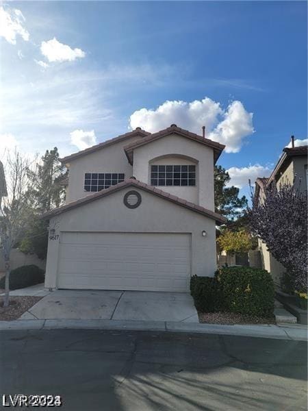 9617 Pine River Ln, Las Vegas, NV 89123 - view of front of property with stucco siding, concrete driveway, a garage, and a tiled roof