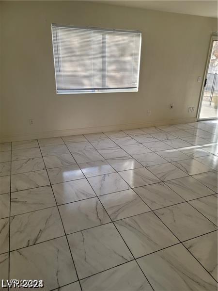 9617 Pine River Ln, Las Vegas, NV 89123 - unfurnished room with baseboards and marble look tiles
