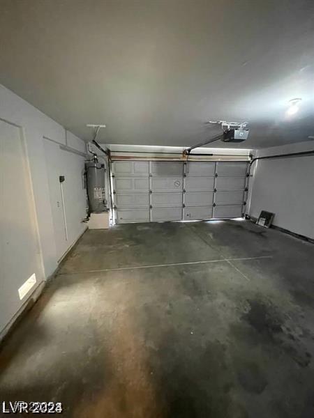 9617 Pine River Ln, Las Vegas, NV 89123 - garage featuring gas water heater and a garage door opener
