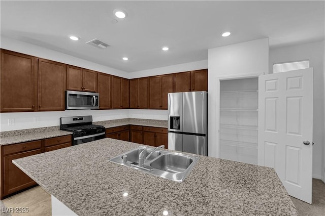 5677 Asyma Ct, Las Vegas, NV 89113 - kitchen featuring stainless steel appliances, recessed lighting, and a center island with sink
