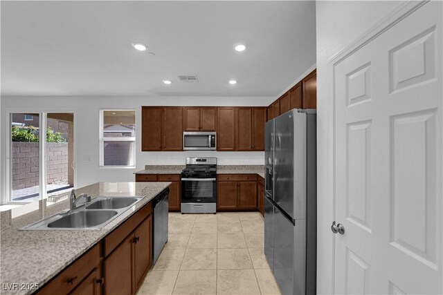 5677 Asyma Ct, Las Vegas, NV 89113 - kitchen featuring appliances with stainless steel finishes, light tile patterned flooring, and recessed lighting