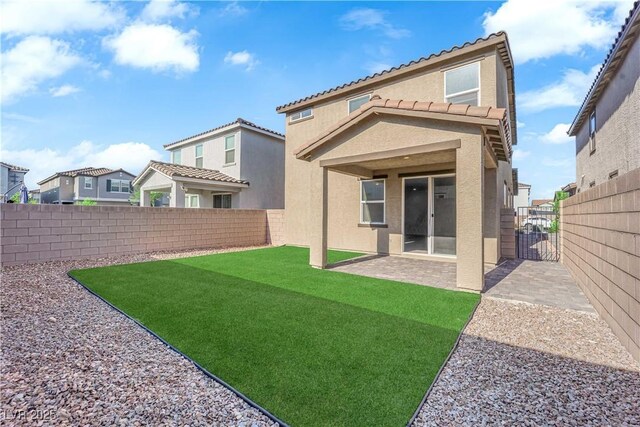 5677 Asyma Ct, Las Vegas, NV 89113 - rear view of house with a fenced backyard, a tiled roof, and stucco siding