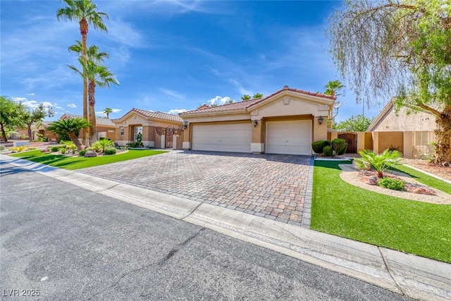 7311 Chaparral Cove Ln, Las Vegas, NV 89131 - mediterranean / spanish-style home featuring stucco siding, decorative driveway, an attached garage, and a tiled roof