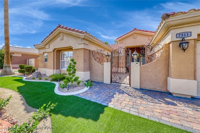 7311 Chaparral Cove Ln, Las Vegas, NV 89131 - view of front of house featuring a gate, stucco siding, and a tile roof