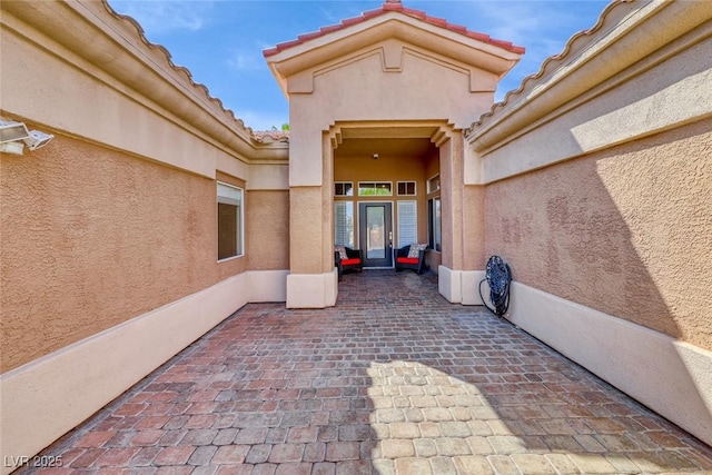 7311 Chaparral Cove Ln, Las Vegas, NV 89131 - property entrance featuring stucco siding, a patio area, and a tiled roof