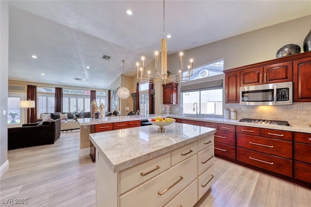7311 Chaparral Cove Ln, Las Vegas, NV 89131 - kitchen featuring appliances with stainless steel finishes, a peninsula, light wood-type flooring, open floor plan, and recessed lighting