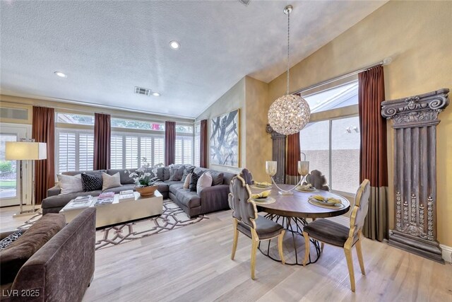 7311 Chaparral Cove Ln, Las Vegas, NV 89131 - dining space with a chandelier, light wood finished floors, and healthy amount of natural light