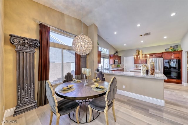 7311 Chaparral Cove Ln, Las Vegas, NV 89131 - dining room featuring a chandelier, light wood-style floors, lofted ceiling, and recessed lighting