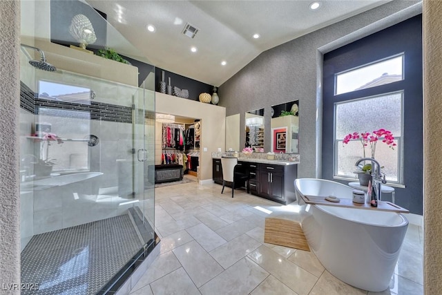 7311 Chaparral Cove Ln, Las Vegas, NV 89131 - bathroom featuring a shower stall, vaulted ceiling, vanity, a freestanding tub, and a walk in closet