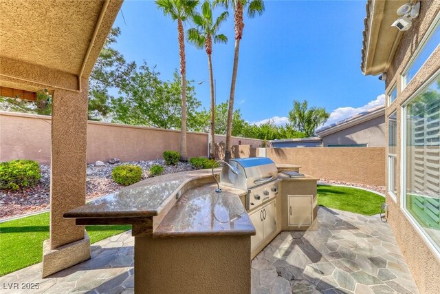 7311 Chaparral Cove Ln, Las Vegas, NV 89131 - fenced backyard featuring an outdoor kitchen and a patio